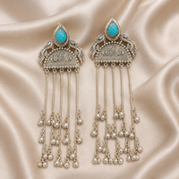 Turquoise cabochon jhumka tassel earrings featuring long silver-tone bell fringe