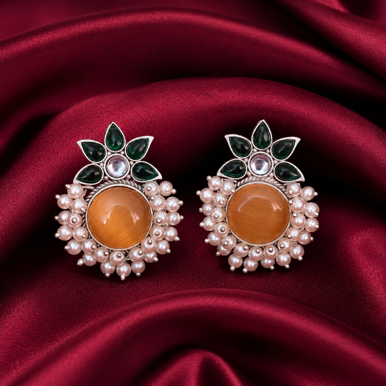 Gold-tone stud earrings with amber round center, green floral leaves, and pearl cluster