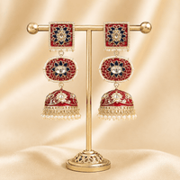 Gold-tone jhumki earrings with red dome drops, square enamel tops, pearl fringe