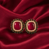 Ruby red square halo stud earrings with emerald green bead border and gold-tone setting