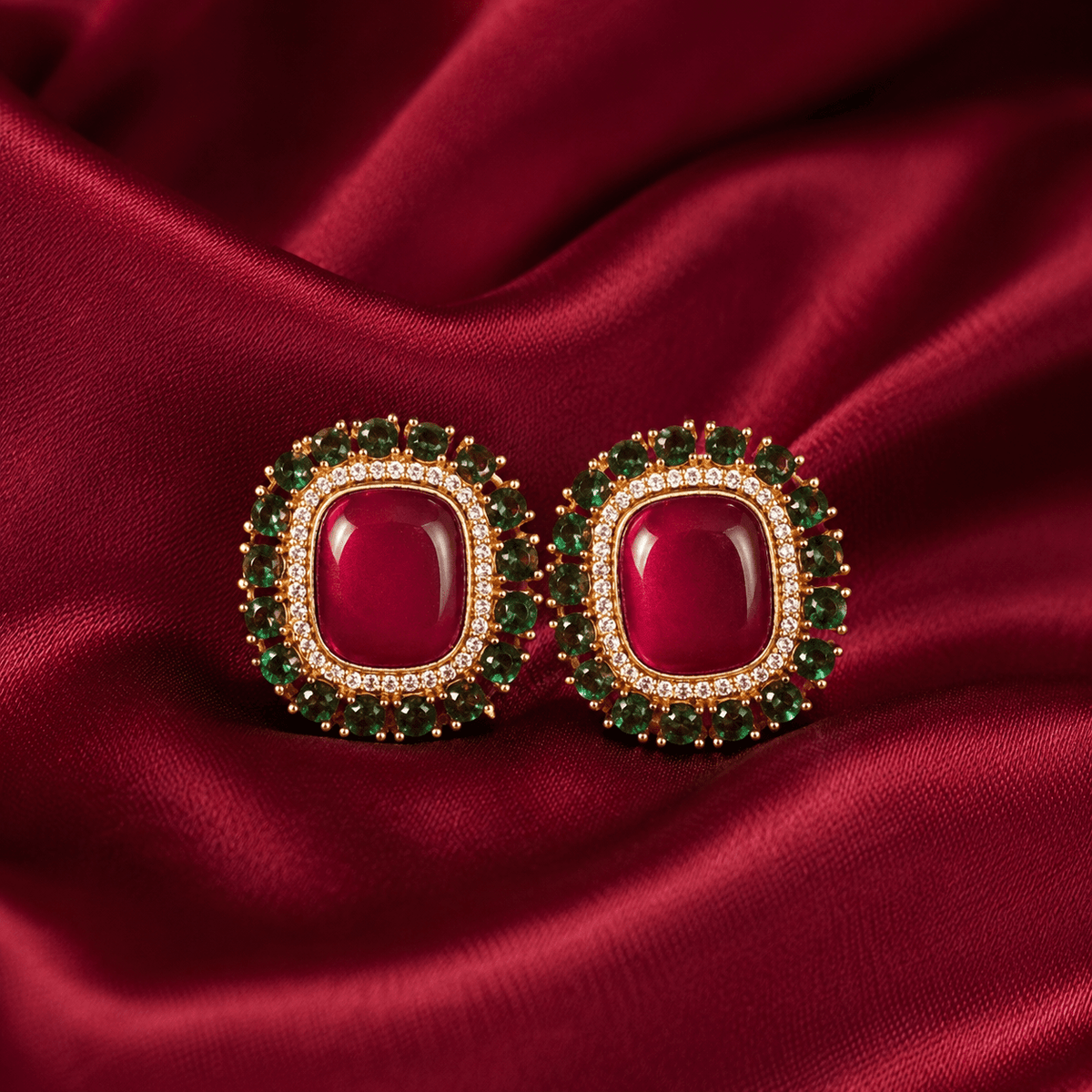 Ruby red square halo stud earrings with emerald green bead border and gold-tone setting