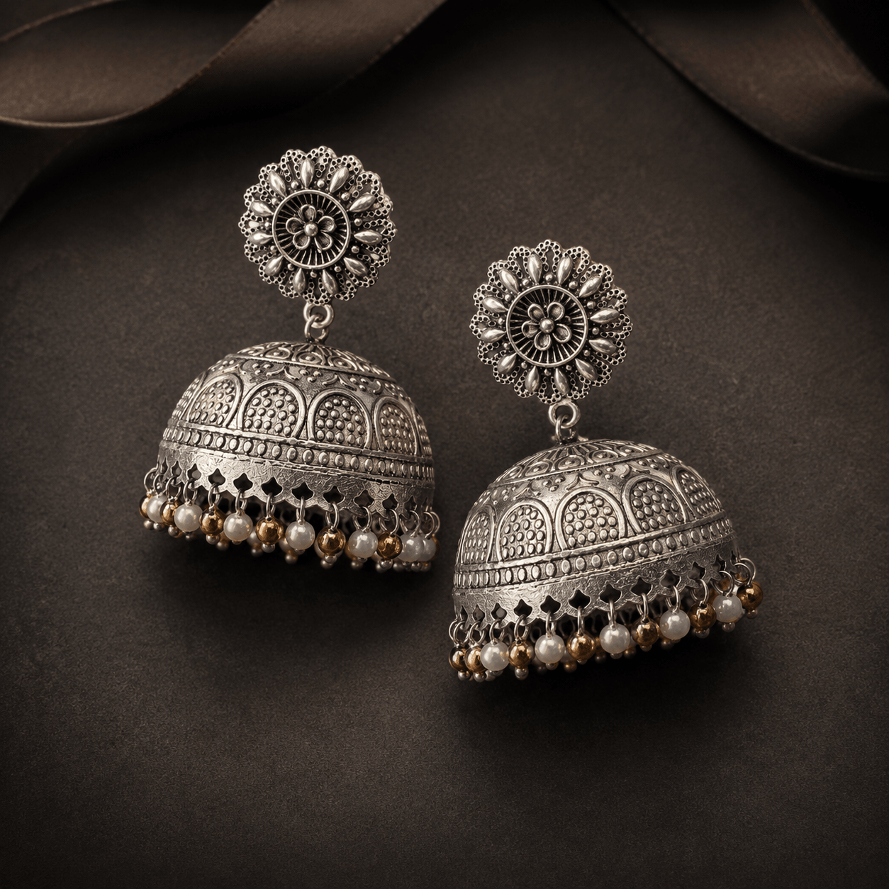 Silver-tone engraved dome jhumki earrings with round floral top and beaded drops